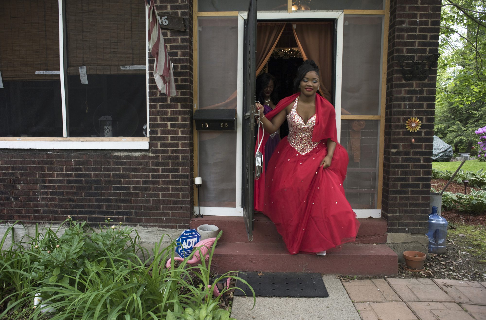 Tyneisha Wilder leaves her foster home in Wilkinsburg for East Allegheny High School's Promenade. Promenade is a high school tradition when the couples line up and are presented before an audience of family, friends and community members. (Photo by Martha Rial/PublicSource)